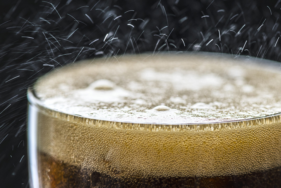 close-up of the top of a carbonated drink in a glass