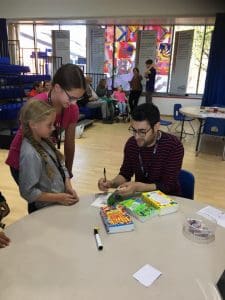 Joshua Seigal signing his poetry books at Potential Plus UK's Big Family Weekend, 2018