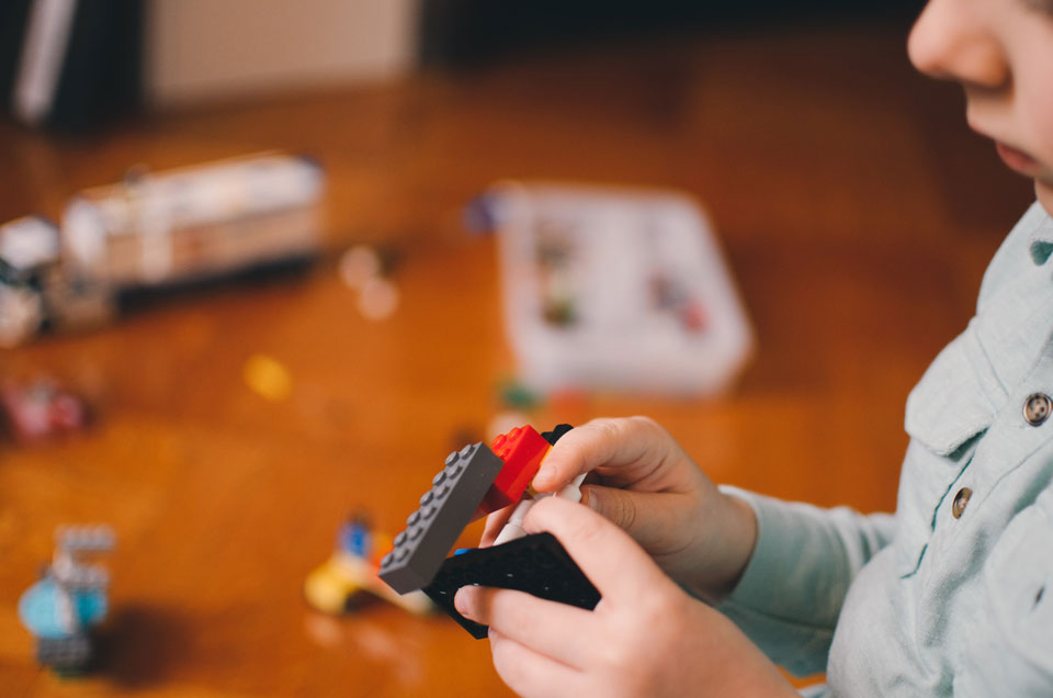 Young child building with lego