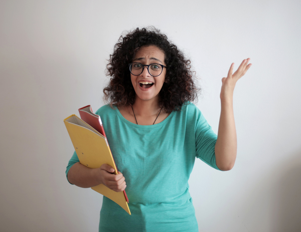 Photo of a woman holding some files