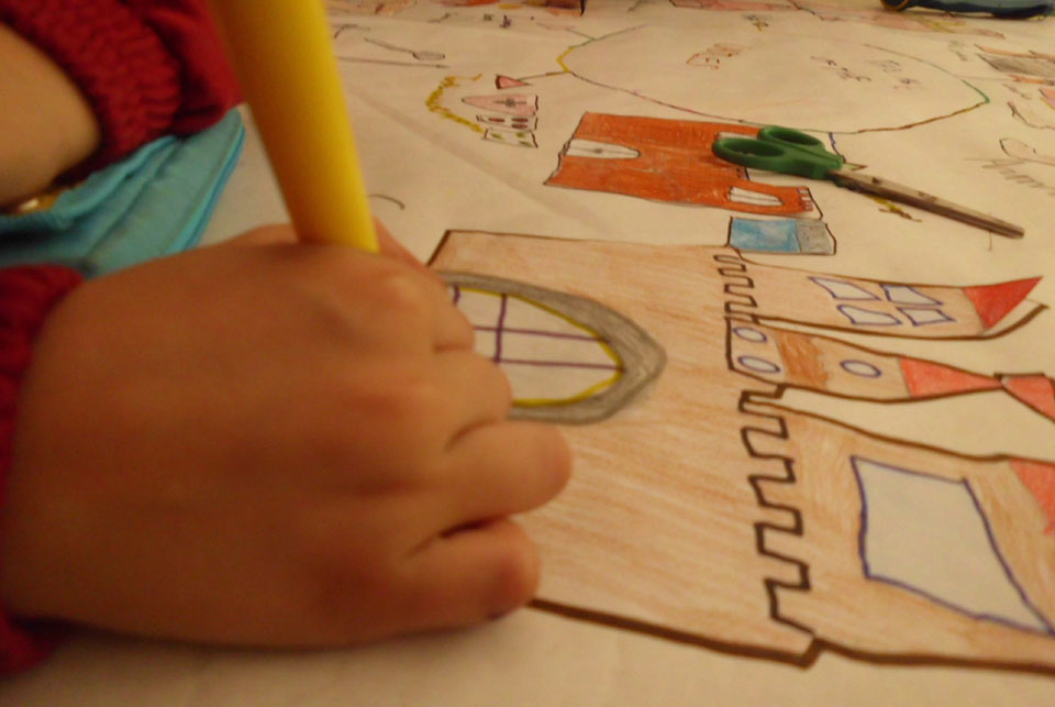 young child drawing a castle