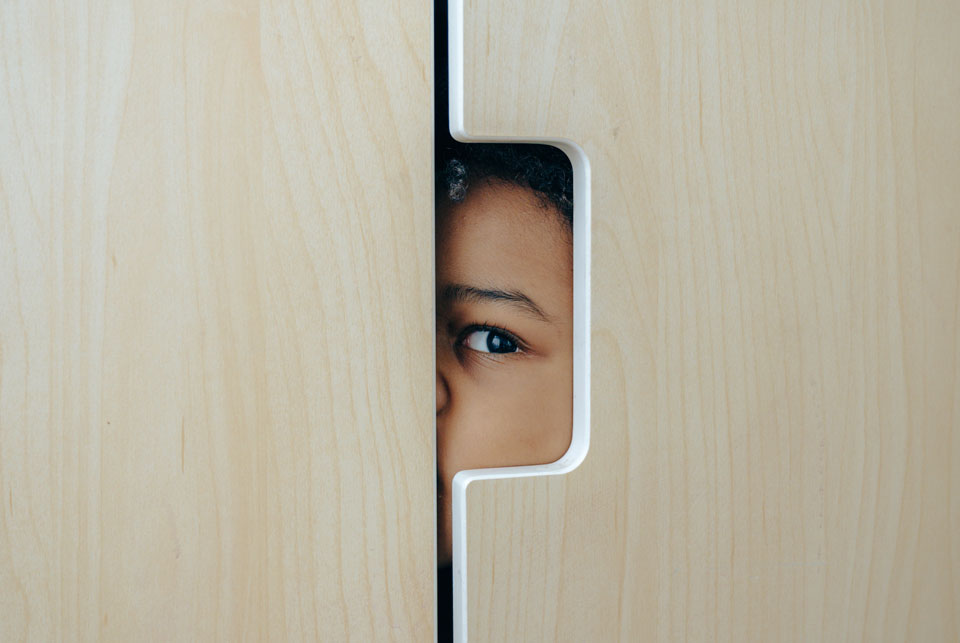 Child's eye looking out of a wardrobe