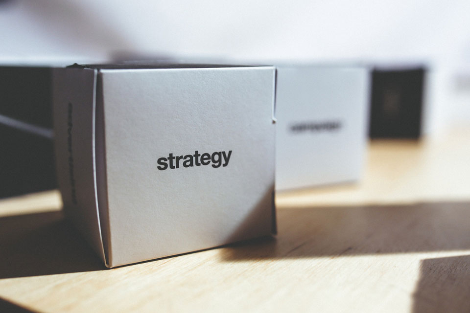 Boxes marked as strategy standing on a table